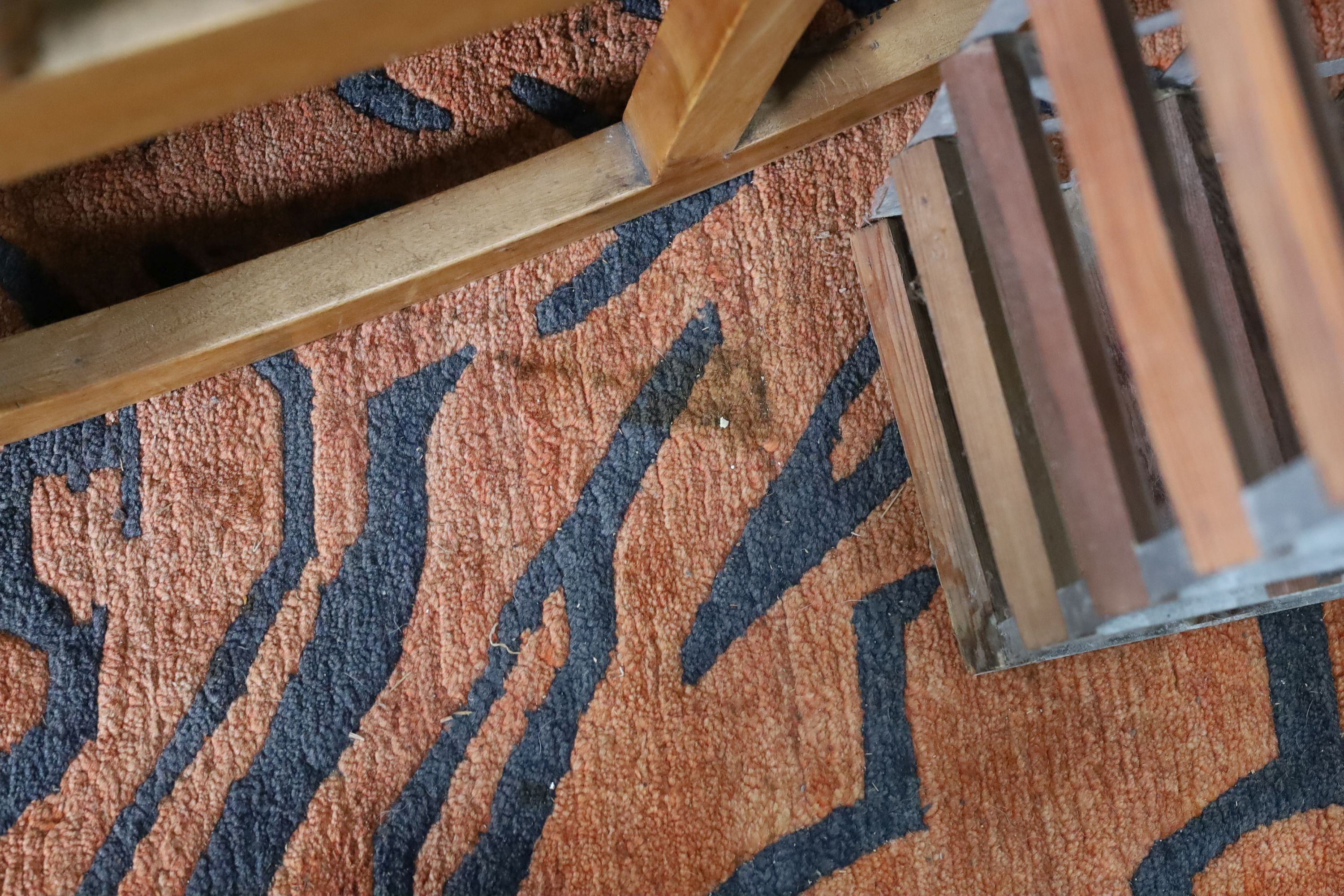 A contemporary red ground zebra striped carpet, 340 x 230cm